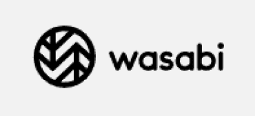 Trustack MSP Cyber Security, IT Services, IT Support. Logo of "wasabi" featuring a stylized black monogram inside a circle, paired with the brand name "wasabi" in lowercase, sans-serif font to the right, reflecting an interior design