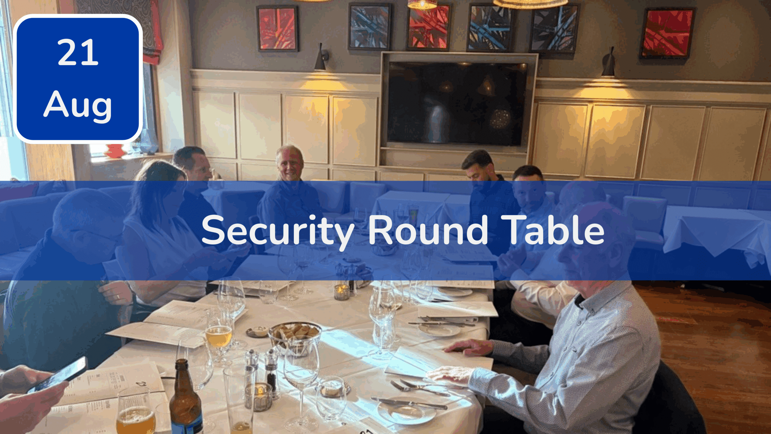 Trustack MSP Cyber Security, IT Services, IT Support. A group of people sit around a restaurant table with drinks, papers, and menus. A banner across the image reads "Security Round Table." Don’t miss Trustack's Upcoming Events! The date "21 Aug" appears in a blue box in the top left corner.