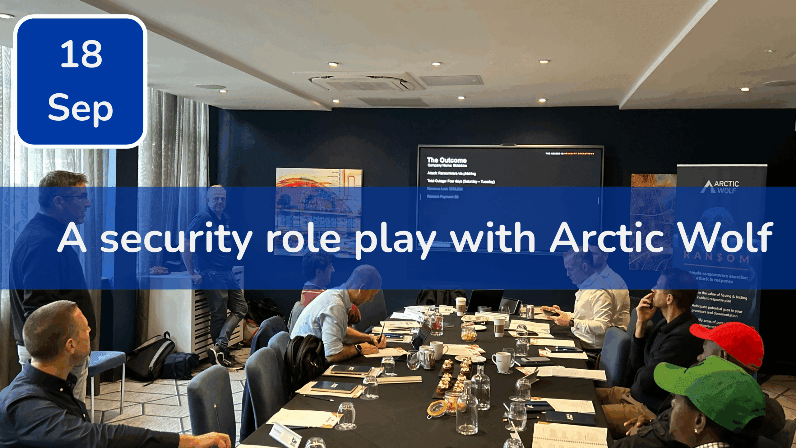 Trustack MSP Cyber Security, IT Services, IT Support. A group of people sit around a conference table with notebooks and drinks, watching a presentation on a large screen. The text overlay reads, "A security role play with Arctic Wolf—part of Trustack's Upcoming Events to not miss. 18 Sep.