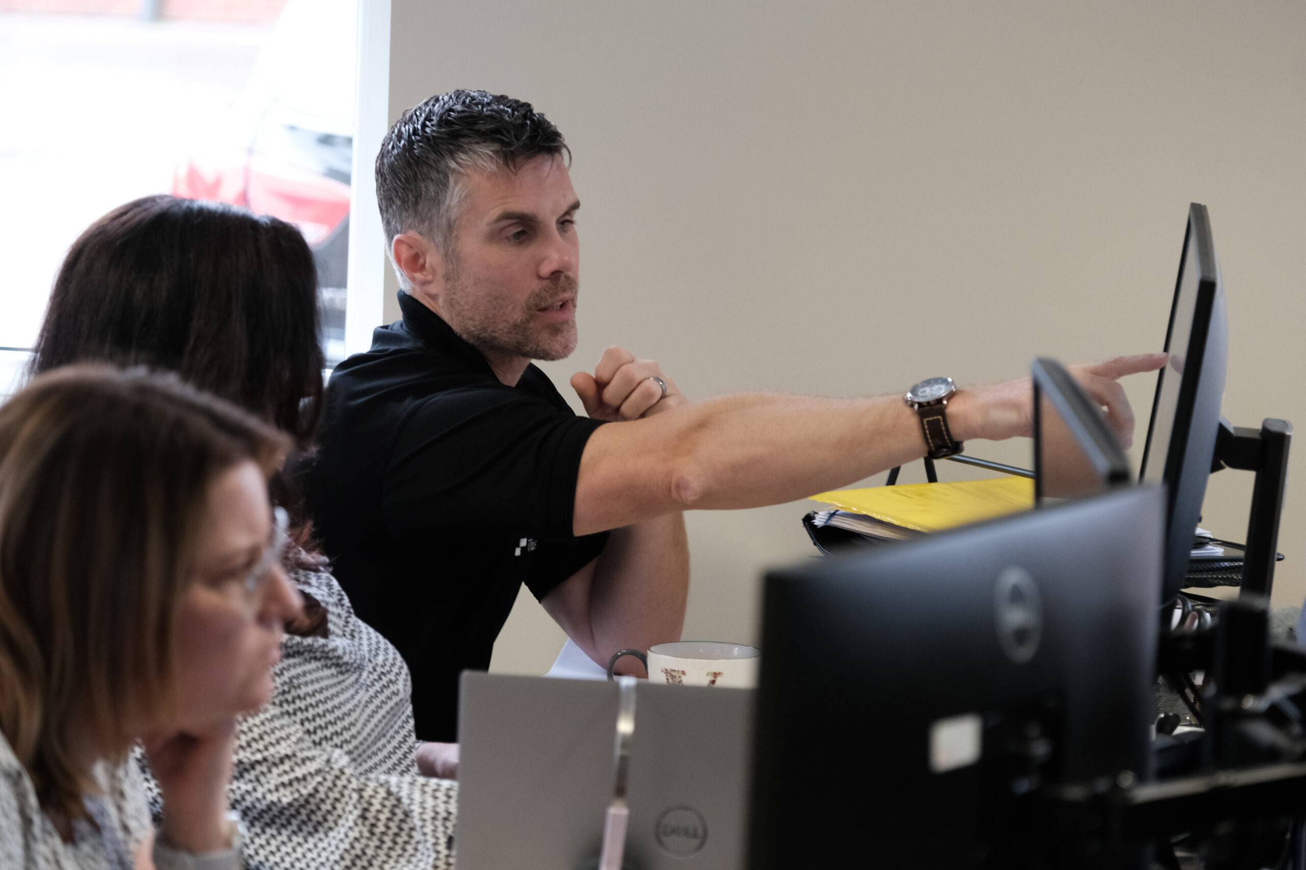 Trustack MSP Cyber Security, IT Services, IT Support. A man pointing at something, illustrating the possibilities with Microsoft Cloud.