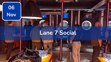 Trustack MSP Cyber Security, IT Services, IT Support. A group of people stand and chat near dartboards in a dimly lit room with red lighting. A blue banner reads "Lane 7 Social," with a date box in the corner—one of Trustack's Upcoming Events not to miss.