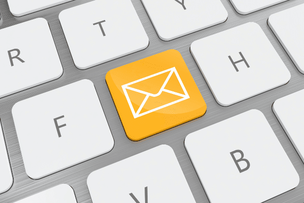 Trustack MSP Cyber Security, IT Services, IT Support. A computer keyboard with a yellow key featuring a white envelope icon, symbolising an Email Gateway, located between the "F" and "H" keys. The rest of the keys are white.