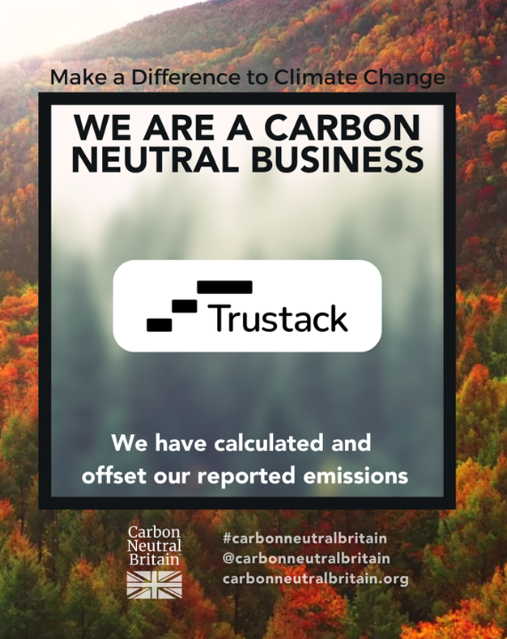 Trustack MSP Cyber Security, IT Services, IT Support. A sign proudly states Trustack has achieved Carbon Neutral Status, with all emissions carefully calculated and fully offset. The background features a serene forest adorned with autumn foliage, whilst logos and social media details for Carbon Neutral Britain are prominently displayed.